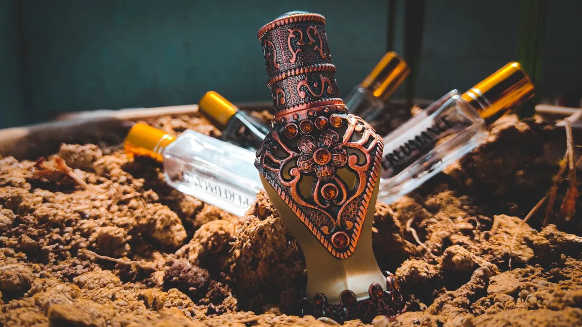 Ornate attar bottles resting in the soil