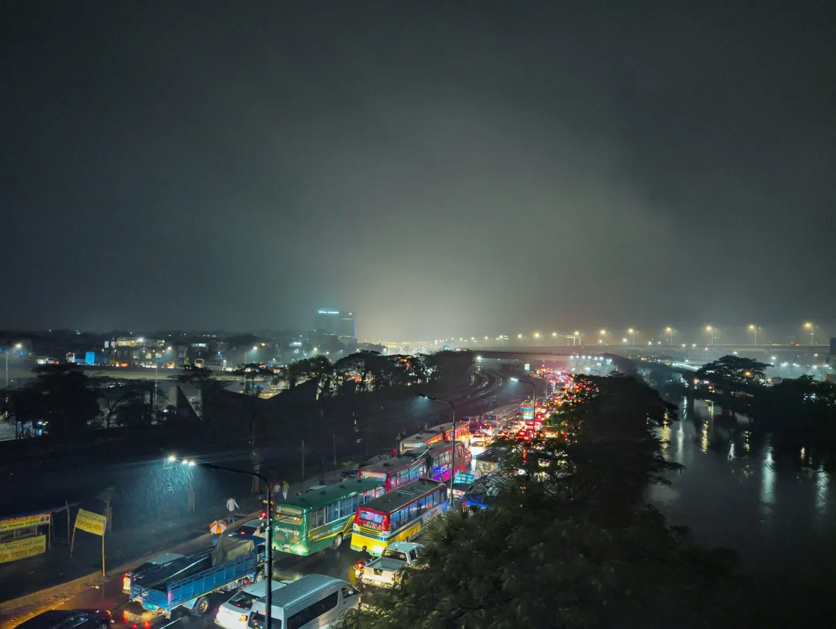 Night traffic streaming along a riverside road